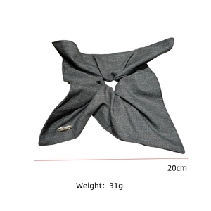 Detail showing grey striped fabric hair accessory with 20cm width and small metal tag
