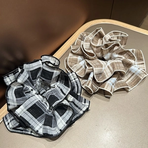 Detailed view of plaid scrunchies in black-white and coffee beige checkered cotton fabric