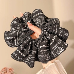 Detailed close-up of navy blue paisley pattern oversized scrunchie with soft fabric texture