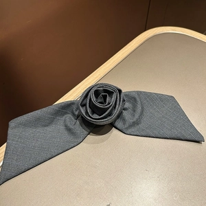 Detail of grey striped fabric rose hair clip with refined 3D floral craftsmanship