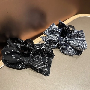 Detail of vintage paisley print bow hair claws in classic black and navy blue fabric
