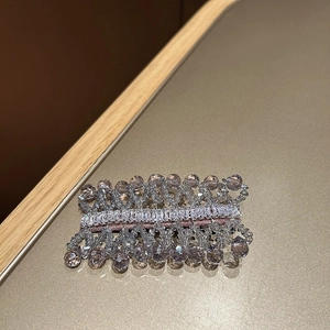 Close-up of handmade lavender crystal beaded hair clip with zircon embellishments