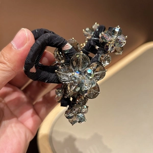 Luxurious crystal flower hair claw with faceted grey crystals and black fabric wrap