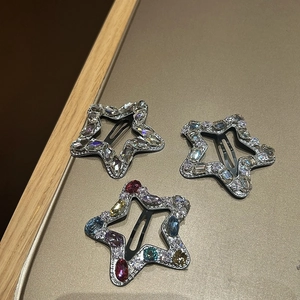 Three-piece star-shaped hair clips set with colorful rhinestones on black metal base