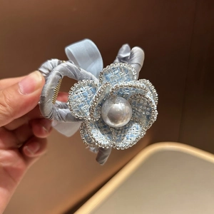 Elegant camellia hair clip with blue tweed fabric, sparkling rhinestones and white pearl