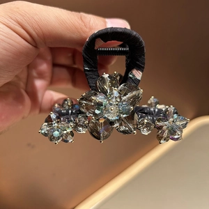 Elegant floral shark clip with grey crystals and black base for sophisticated hairstyling