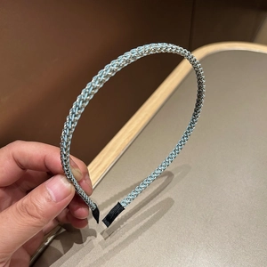 Détail du serre-tête tressé bleu clair avec fils métalliques argentés et embouts doux