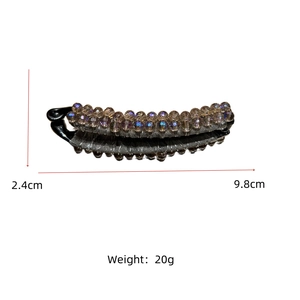 Detail view of crystal banana clip with 9.8cm length and 2.4cm height dimensions