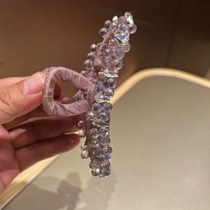 Detail of lavender fabric hair claw clip with sparkling crystals and faceted beads