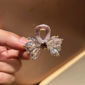 Pink rhinestone wavy headband with crystal accents for high-volume hairstyle