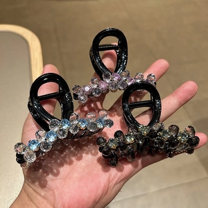 Three elegant crystal beaded hair claws in pink, blue, and grey for women's updos