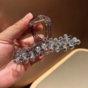 Luxurious purple crystal hair claw clip with sparkling rhinestones and gold spring