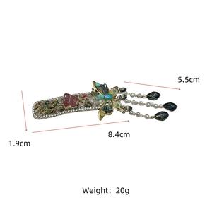 Detail view of green crystal butterfly hair clip with tassel and dimension markings