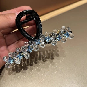 Elegant crystal beaded hair claw clip with blue and clear stones on black base