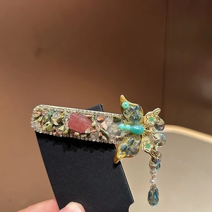 Elegant green butterfly hair clip with crystal tassels and pink stone on black card