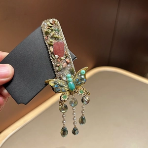 Elegant Chinese butterfly hair clip with green crystals, pearls, and tassel fringe