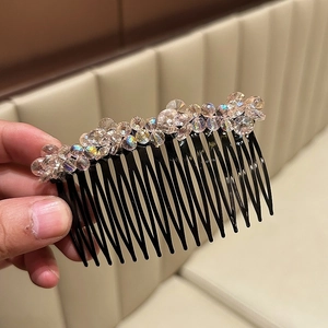 Elegant hair comb with sparkling champagne crystals on a black base for hairstyles