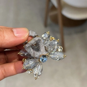 Detail shot of elegant blue water-drop crystals arranged on a luxury hair clip accessory