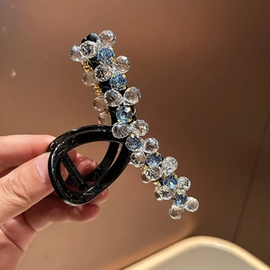 Detail of luxury crystal beaded hair claw clip with blue and clear faceted beads