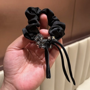 Elegant black satin scrunchie with sparkling crystal cluster and flowing ribbon streamers