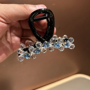 Detailed close-up of a crystal beaded hair claw clip featuring elegant blue and clear gems