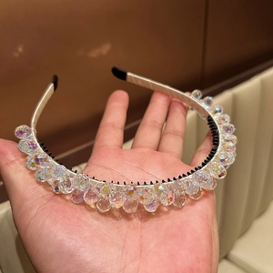 Close-up of colorful crystal beads on a white fabric headband with anti-slip teeth