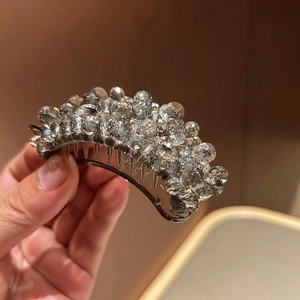 Detailed close-up of sparkling crystal beads and durable teeth on the banana hair clip
