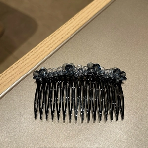 Detail of multi-tooth hair comb with deep blue and grey crystal beads for hair styling