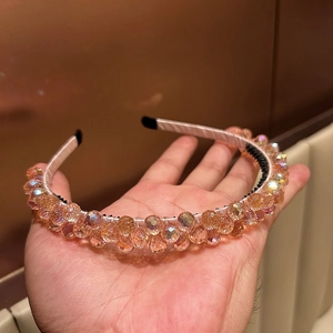 Elegant iridescent crystal beaded headband in peach pink with non-slip inner grip