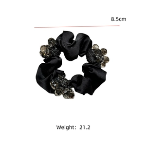 Detail view of black satin scrunchie with grey beads showing 8.5cm diameter size