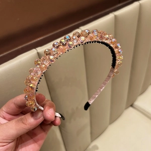 Detail of handmade beaded crystal headband with non-slip teeth and sparkling finish
