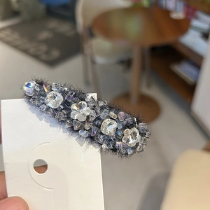 Elegant rhinestone hair clip with grey faux fur base and sparkling crystal flower details