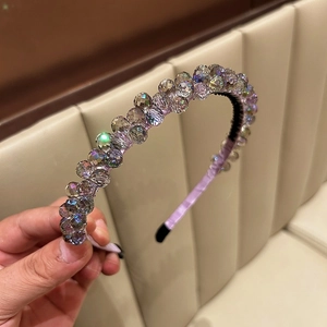 Close-up of a handmade lavender crystal beaded headband with multi-faceted glass stones