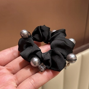 Elegant black satin scrunchie with faux pearls and beads for stylish ponytails