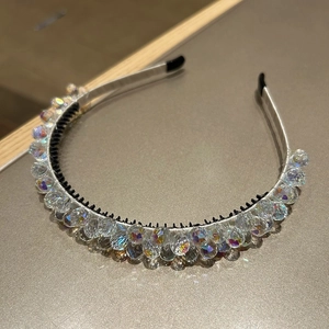 Macro detail of luxury crystal-encrusted headband with iridescent glass beads