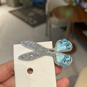 Chic silver scissors-shaped hair clip with blue heart gemstone and sparkling rhinestones