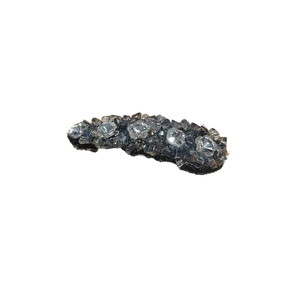 Elegant rhinestone hair clip with grey and clear crystals on a dark base