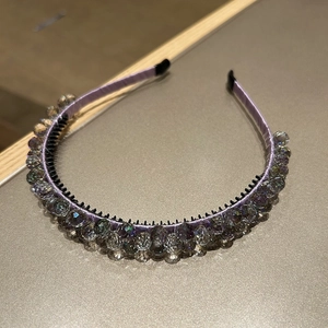 Detail of lavender satin headband with crystal beads and anti-slip comb teeth design