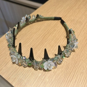 Detailed shot of Lily of the Valley headband with crystal beads and white flowers