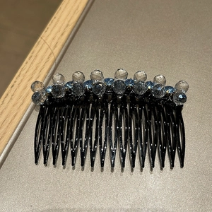 Close-up of a 14-tooth hair comb with elegant blue and clear crystal beads decoration