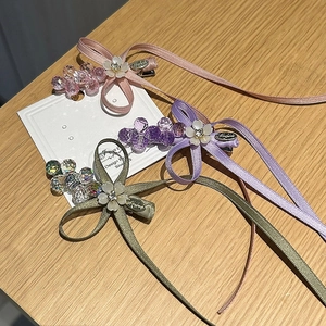 Vue détaillée de trois pinces à cheveux à nœud avec perles de cristal et fleurs