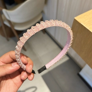 Détail de perles de cristal roses sur un serre-tête large avec tissu doux interne