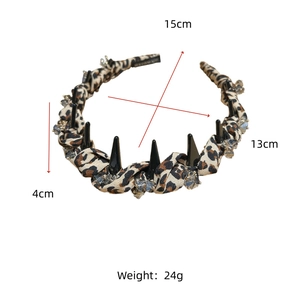 Detail view of leopard print headband with black spikes, crystals and dimensions