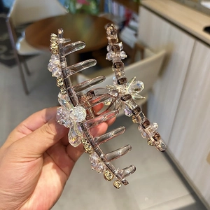 Detail of flower hair claw clip with hand-woven crystals and rhinestones for elegant hair styling