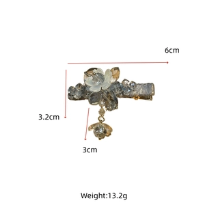 Detail showing dimensions of the crystal hair clip with a white floral charm