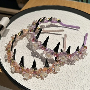 Detail view of crystal beaded headbands in pink and purple with floral accents