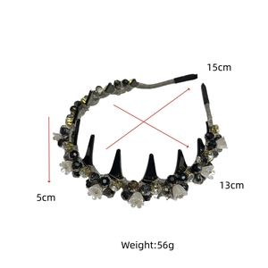 Detail view of crystal headband with black spikes and white flower beads showing 15cm size