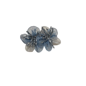 Elegant organza flower hair clip with crystal beadwork on a minimalist white background