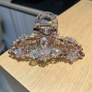 Detail of flower crystal hair claw with champagne rhinestones and sturdy metal spring