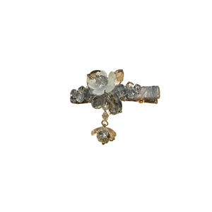 Elegant floral duckbill hair clip featuring light blue crystals and a pendant on white background